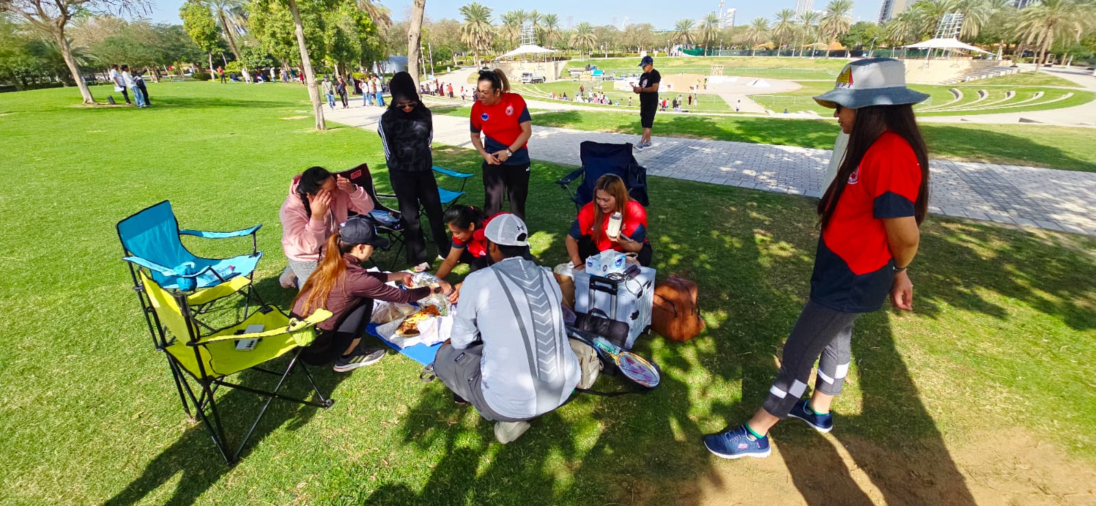 A group taking a meal break together during an outdoor gathering