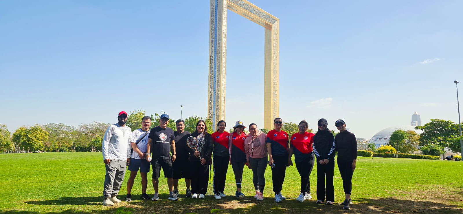 A group standing together in front of the Dubai Frame